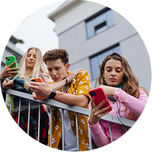 Three young people looking at phones