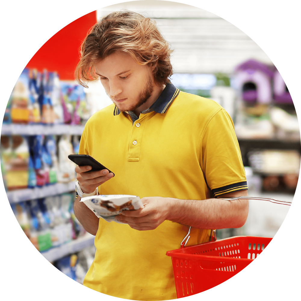 Man in grocery story looking at phone